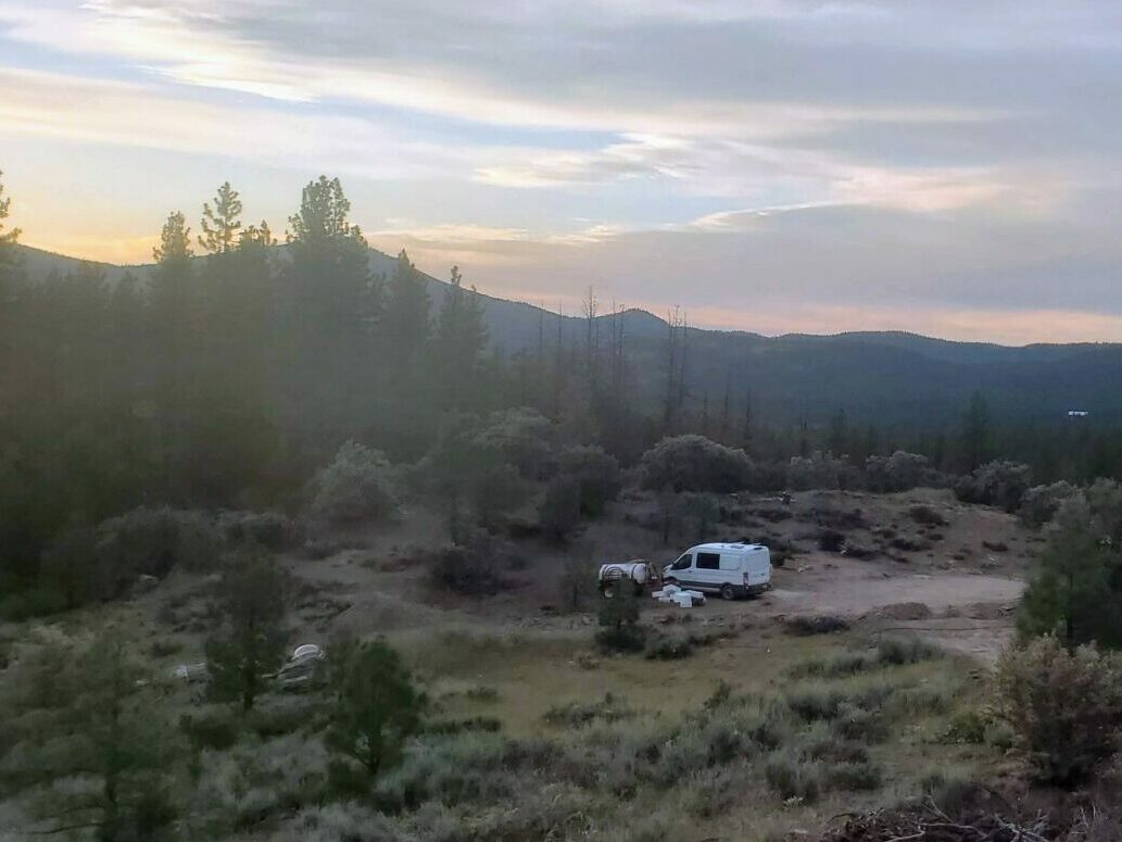 Campervan parked at High Camp at sunset with mountain views
