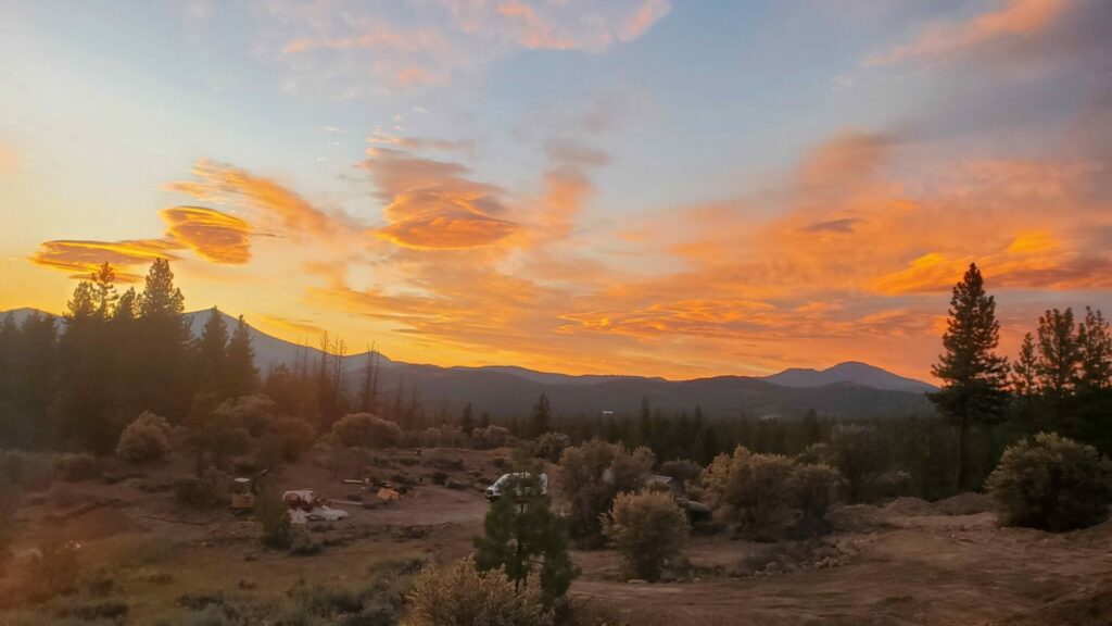 Fiery sunset over the High Camp property with mountain views across the Lost Sierra