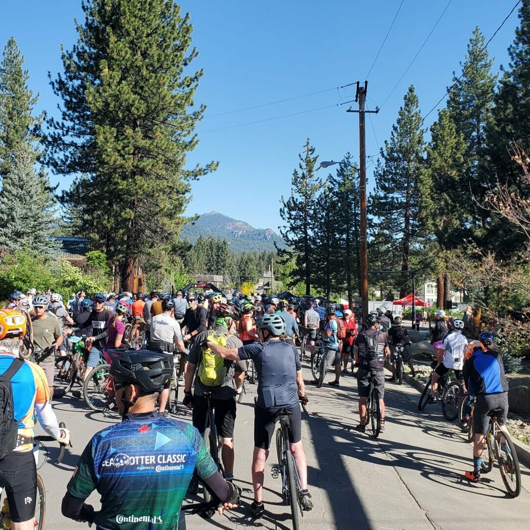 Crowd of cyclists gathered at the Lost and Found Gravel Festival start line in Portola