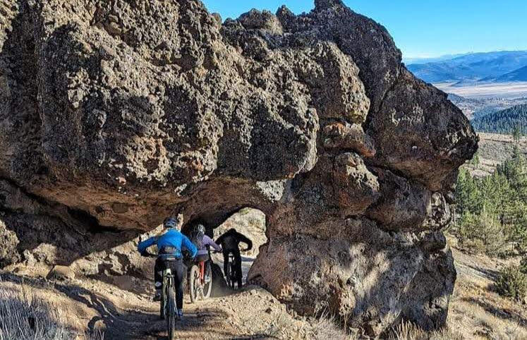 Mountain biker on the Beckwourth Peak Trail arch feature, Lost Sierra