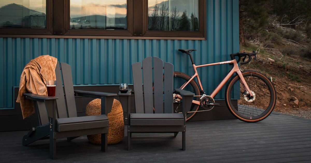 Adirondack chairs and gravel bike on cabin deck at Beckwourth Peak High Camp at sunset