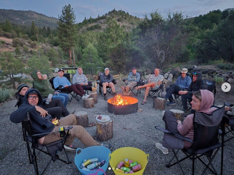 Guests gathered around the communal fire pit at High Camp in the Lost Sierra